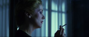 Movie still from “The Hunger” (1983), directed by Tony Scott – A person holding a cigarette in her mouth; Close Up shot, Low angle