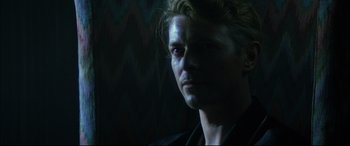 Movie still from “The Hunger” (1983), directed by Tony Scott – A person wearing a black jacket; Close Up shot, Over the shoulder angle