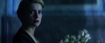 Movie still from “The Hunger” (1983), directed by Tony Scott – A person wearing a suit and tie; Close Up shot, Over the shoulder angle