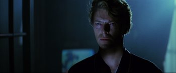 Movie still from “The Hunger” (1983), directed by Tony Scott – A person wearing a black shirt; Close Up shot, Over the shoulder angle
