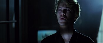 Movie still from “The Hunger” (1983), directed by Tony Scott – A man in a black shirt is looking at a monitor; Close Up shot, Low angle