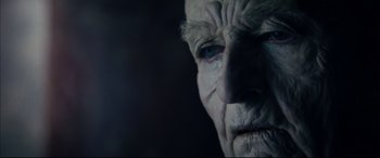 Movie still from “The Hunger” (1983), directed by Tony Scott – An old man's face is shown in the dark; Extreme Close Up shot, Over the shoulder angle