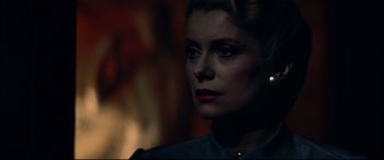 Movie still from “The Hunger” (1983), directed by Tony Scott – A person wearing a suit and tie; Close Up shot, Over the shoulder angle