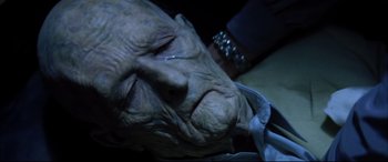 Movie still from “The Hunger” (1983), directed by Tony Scott – An old man is crying while sitting on a chair; Close Up shot, High angle