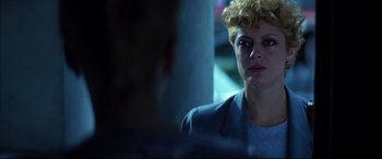 Movie still from “The Hunger” (1983), directed by Tony Scott – A woman is sitting in front of a window; Close Up shot, Over the shoulder angle