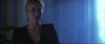 Movie still from “The Hunger” (1983), directed by Tony Scott – A woman in a black dress is looking at the camera; Close Up shot, Low angle