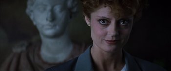 Movie still from “The Hunger” (1983), directed by Tony Scott – A person with a statue in the background; Close Up shot, Low angle