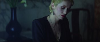 Movie still from “The Hunger” (1983), directed by Tony Scott – A woman wearing a necklace and a black dress; Close Up shot, Low angle