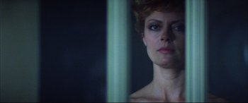 Movie still from “The Hunger” (1983), directed by Tony Scott – A person in a dark room; Close Up shot, Low angle