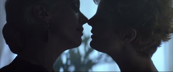 Movie still from “The Hunger” (1983), directed by Tony Scott – Two women face to face in a close up view; Close Up shot, Low angle