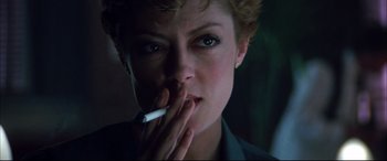 Movie still from “The Hunger” (1983), directed by Tony Scott – A person holding a cigarette in her mouth; Close Up shot, Low angle