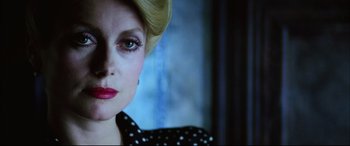 Movie still from “The Hunger” (1983), directed by Tony Scott – A person wearing a polka dot dress; Close Up shot, Low angle