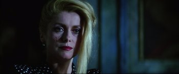 Movie still from “The Hunger” (1983), directed by Tony Scott – A person with long blonde hair; Close Up shot, Low angle