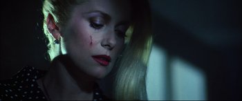 Movie still from “The Hunger” (1983), directed by Tony Scott – A person with a wound on her face; Close Up shot, High angle