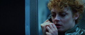 Movie still from “The Hunger” (1983), directed by Tony Scott – A woman with curly red hair talking on a phone; Close Up shot, Low angle