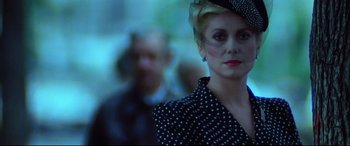 Movie still from “The Hunger” (1983), directed by Tony Scott – A person wearing a hat; Close Up shot, Low angle