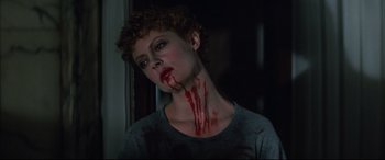 Movie still from “The Hunger” (1983), directed by Tony Scott – A woman with blood on her face and neck; Close Up shot, Low angle