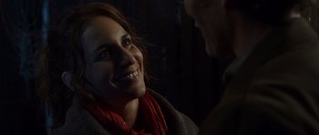 Movie still from “The Hunt” (2012), directed by Thomas Vinterberg – A woman smiles at a man in a red scarf; Close Up shot, Over the shoulder angle