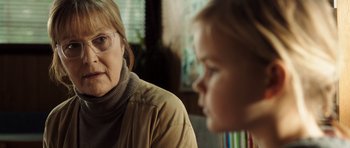 Movie still from “The Hunt” (2012), directed by Thomas Vinterberg – An older woman sitting next to a young child; Close Up shot, Over the shoulder angle
