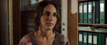 Movie still from “The Hunt” (2012), directed by Thomas Vinterberg – A person wearing a sweater near a door; Close Up shot, Over the shoulder angle