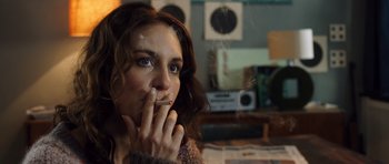 Movie still from “The Hunt” (2012), directed by Thomas Vinterberg – A person smoking a cigarette in a room; Close Up shot, Over the shoulder angle