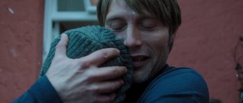 Movie still from “The Hunt” (2012), directed by Thomas Vinterberg – A person holding a blanket; Close Up shot, Over the shoulder angle