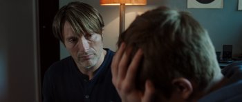 Movie still from “The Hunt” (2012), directed by Thomas Vinterberg – A man looking at his reflection in a mirror; Close Up shot, Over the shoulder angle
