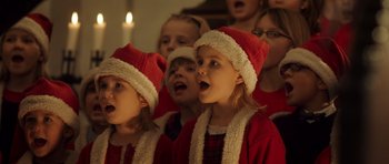 Movie still from “The Hunt” (2012), directed by Thomas Vinterberg – A group of young children singing in a choir; Close Up shot, High angle