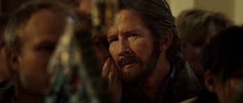 Movie still from “The Hunt” (2012), directed by Thomas Vinterberg – A person with long hair and a beard; Close Up shot, Over the shoulder angle