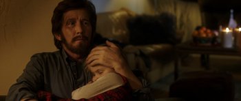 Movie still from “The Hunt” (2012), directed by Thomas Vinterberg – A man holding a child in his arms; Close Up shot, Over the shoulder angle