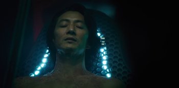 Movie still from “Altered Carbon” (2018), created by Laeta Kalogridis – A man with his eyes closed in a dark room; Close Up shot, Low angle