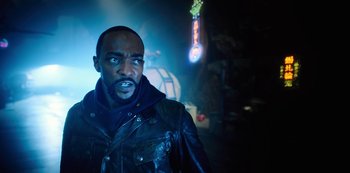 Movie still from “Altered Carbon” (2018), created by Laeta Kalogridis – A man wearing a leather jacket standing next to a neon sign; Close Up shot, Over the shoulder angle