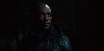 Movie still from “Altered Carbon” (2018), created by Laeta Kalogridis – A man wearing a black leather jacket and a hood; Close Up shot, Low angle