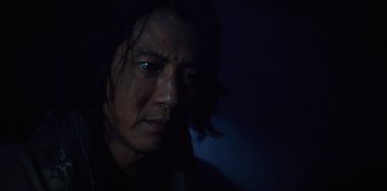 Movie still from “Altered Carbon” (2018), created by Laeta Kalogridis – A person with long black hair; Close Up shot, Low angle