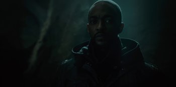 Movie still from “Altered Carbon” (2018), created by Laeta Kalogridis – A man in a black jacket is standing in the dark; Close Up shot, Low angle