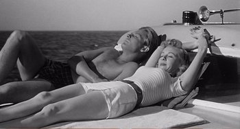 Movie still from “The Incredible Shrinking Man” (1957), directed by Jack Arnold – Two people laying on a boat in the water; Medium shot, High angle