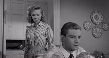 Movie still from “The Incredible Shrinking Man” (1957), directed by Jack Arnold – A man and a woman are standing in a room; Medium shot, Low angle