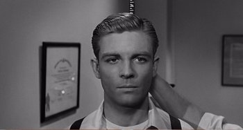 Movie still from “The Incredible Shrinking Man” (1957), directed by Jack Arnold – A young man getting his hair combed by a barber; Close Up shot, Over the shoulder angle