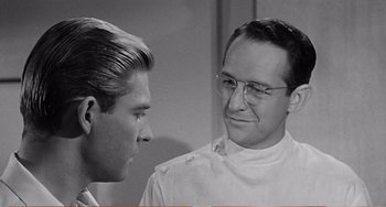 Movie still from “The Incredible Shrinking Man” (1957), directed by Jack Arnold – A man and a woman talking to each other; Close Up shot, Over the shoulder angle