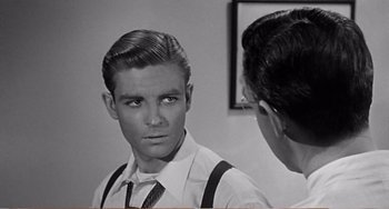 Movie still from “The Incredible Shrinking Man” (1957), directed by Jack Arnold – A young man looking at himself in the mirror; Close Up shot, Over the shoulder angle