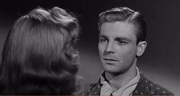 Movie still from “The Incredible Shrinking Man” (1957), directed by Jack Arnold – A young man and a young woman looking at each other; Close Up shot, Over the shoulder angle