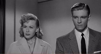 Movie still from “The Incredible Shrinking Man” (1957), directed by Jack Arnold – A man and a woman standing next to each other; Medium shot, Low angle