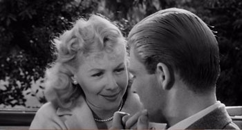 Movie still from “The Incredible Shrinking Man” (1957), directed by Jack Arnold – An old photo of a man and a woman looking at each other; Close Up shot, Over the shoulder angle