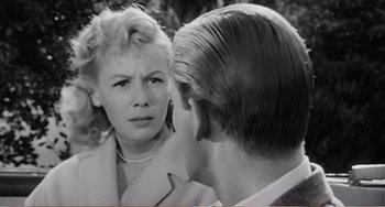 Movie still from “The Incredible Shrinking Man” (1957), directed by Jack Arnold – An old black and white photo of a man and a woman looking at each other; Close Up shot, Over the shoulder angle