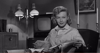 Movie still from “The Incredible Shrinking Man” (1957), directed by Jack Arnold – An old black and white photo of a woman in a room; Medium shot, Low angle