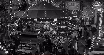 Movie still from “The Incredible Shrinking Man” (1957), directed by Jack Arnold – A black and white photo of people at an amusement park; Extreme Wide shot, High angle