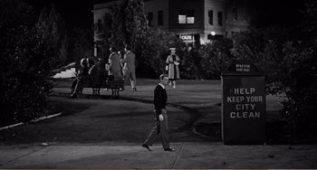 Movie still from “The Incredible Shrinking Man” (1957), directed by Jack Arnold – A man walking down a sidewalk at night; Wide shot, High angle
