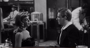 Movie still from “The Incredible Shrinking Man” (1957), directed by Jack Arnold – A man and a woman talking to each other; Medium shot, Over the shoulder angle