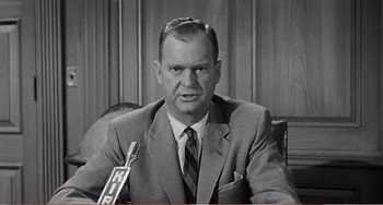 Movie still from “The Incredible Shrinking Man” (1957), directed by Jack Arnold – An older man in a suit and tie; Close Up shot, Low angle