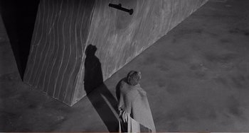 Movie still from “The Incredible Shrinking Man” (1957), directed by Jack Arnold – A person riding a skate board at a skate park; Extreme Wide shot, High angle
